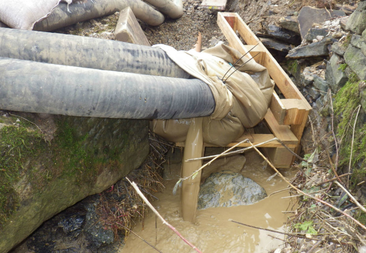 The firm's attempt to contain the muddy water was inadequate; silt was seen flowing off the site