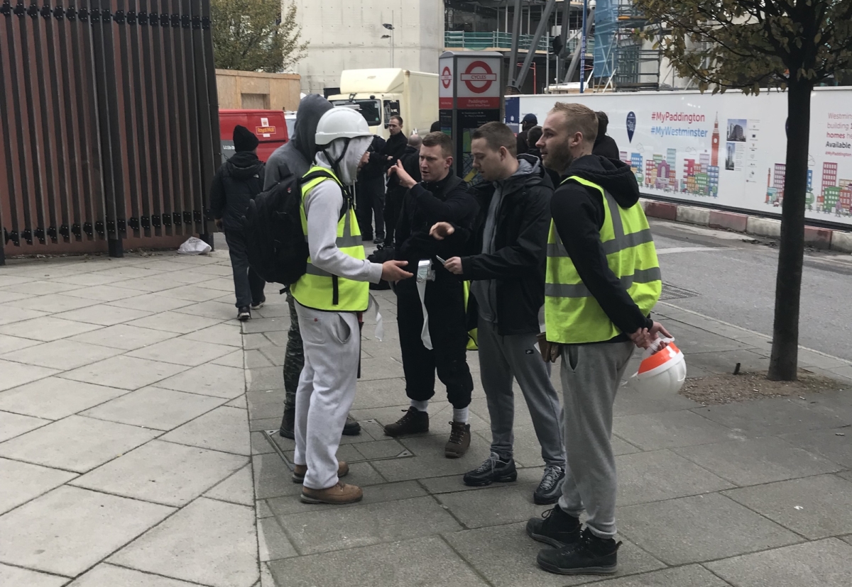 Workers gather at the site gates on Wednesday