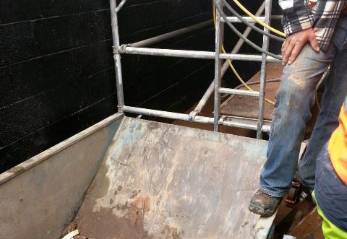 Harrison fell into a skip at the bottom of the lift pit