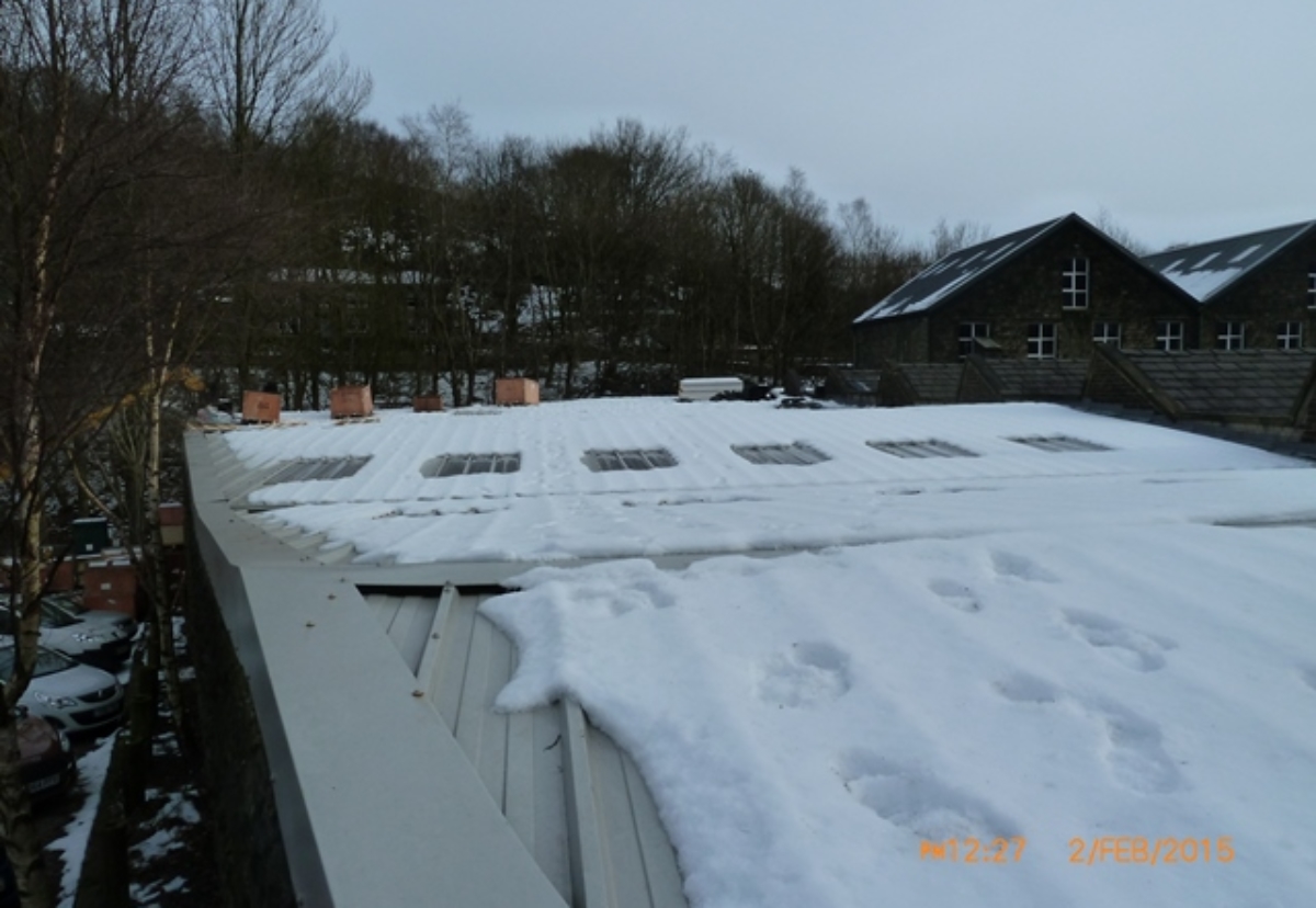 The snow covered roof with unguarded skylights and no edge protection