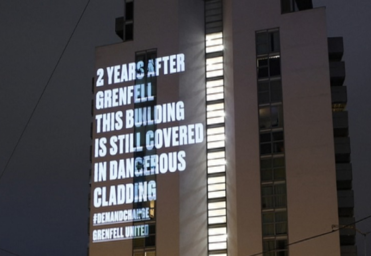 Grenfell Campaigners project fire safety warning onto a Manchester block (Credit: Grenfell United)
