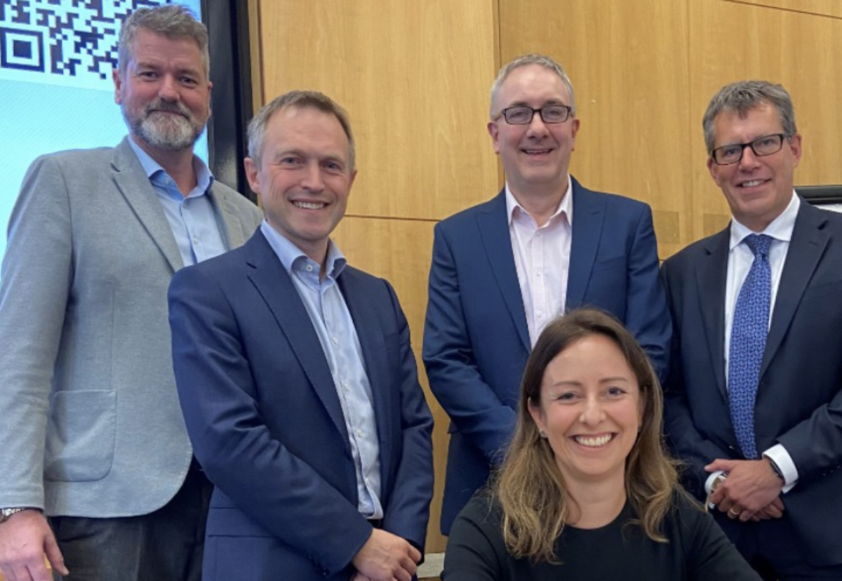 Sandie Forte-Gill (seated), National Highways Director is joined at the contract signing by (left to right) Richard French (Kier), Simon Ellison (Costain), Phil Clifton (Balfour Beatty) and Darren James (Keltbray).