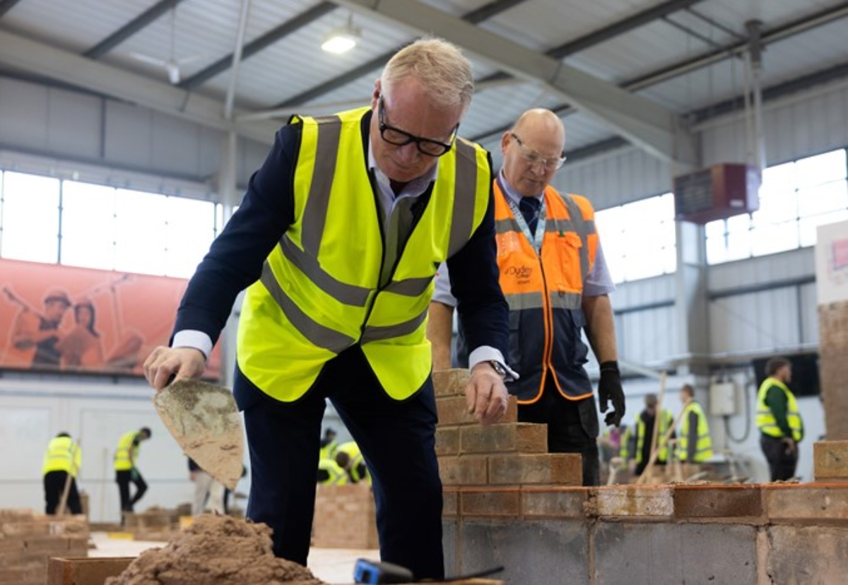 Mayor Richard Parker learns the art of brick laying at Dudley College 