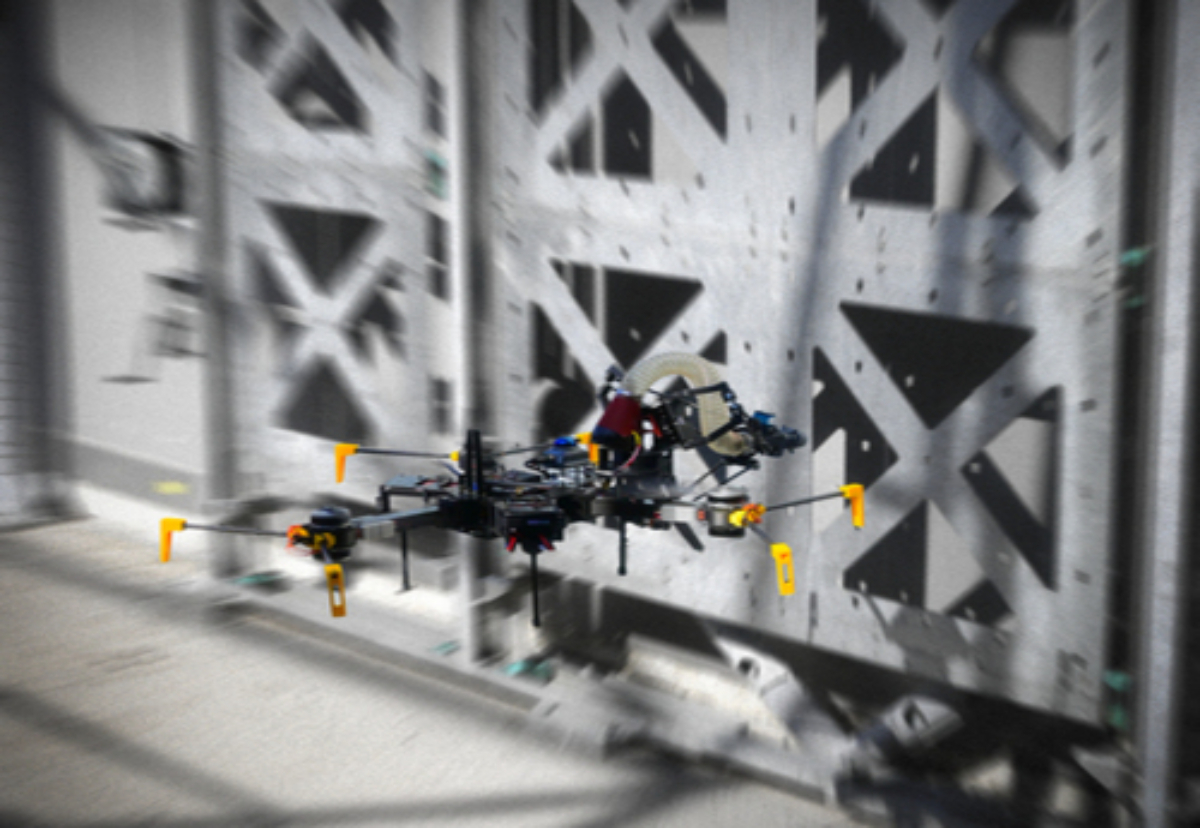 Experiments with flying construction robots on the test wall of the DroneHub with modular components 
