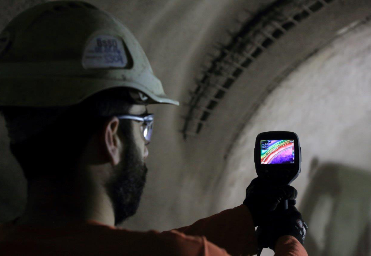 Francisco Gallego, Section Engineer, uses a thermal imaging camera to monitor a section of sprayed concrete lining within the Concourse 1 tunnel at Bond Street Station Upgrade