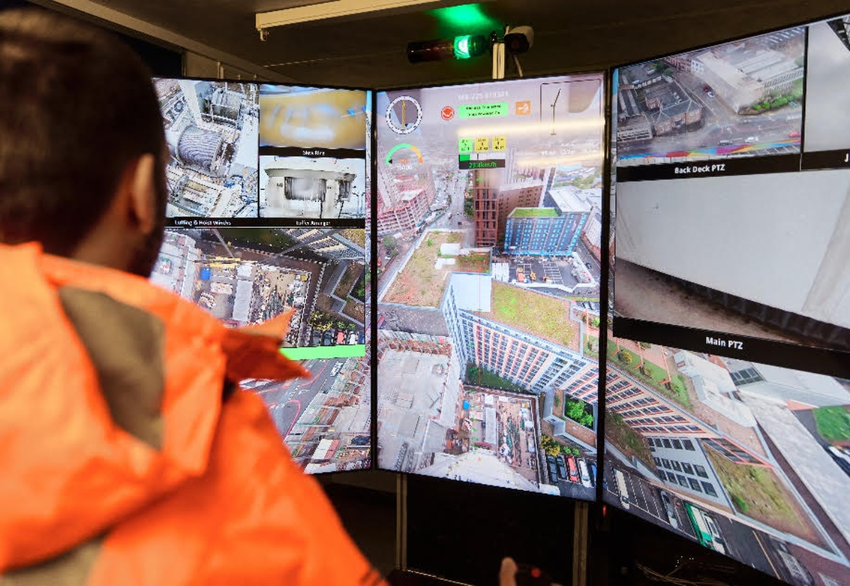 Crane operator in front of the Skyline Cockpit ground command centre’s panoramic screens at Winvic project Crown Place Birmingham